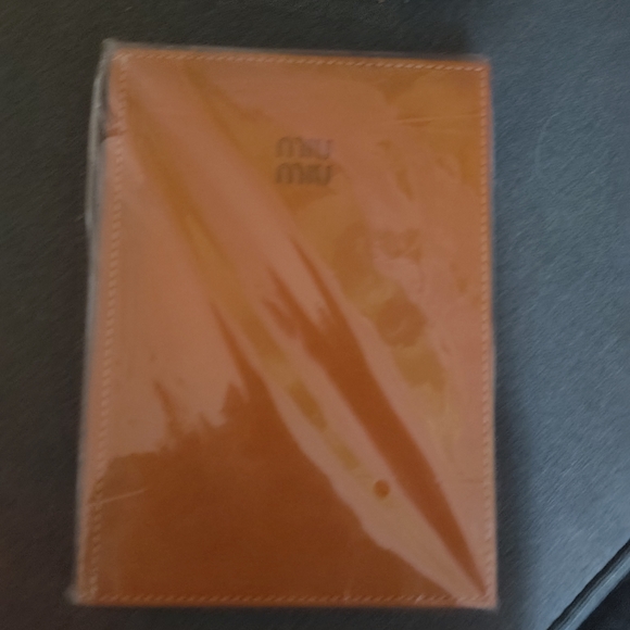 Miu Miu Accessories - Miu Miu Vibrant Orange Leather Cover